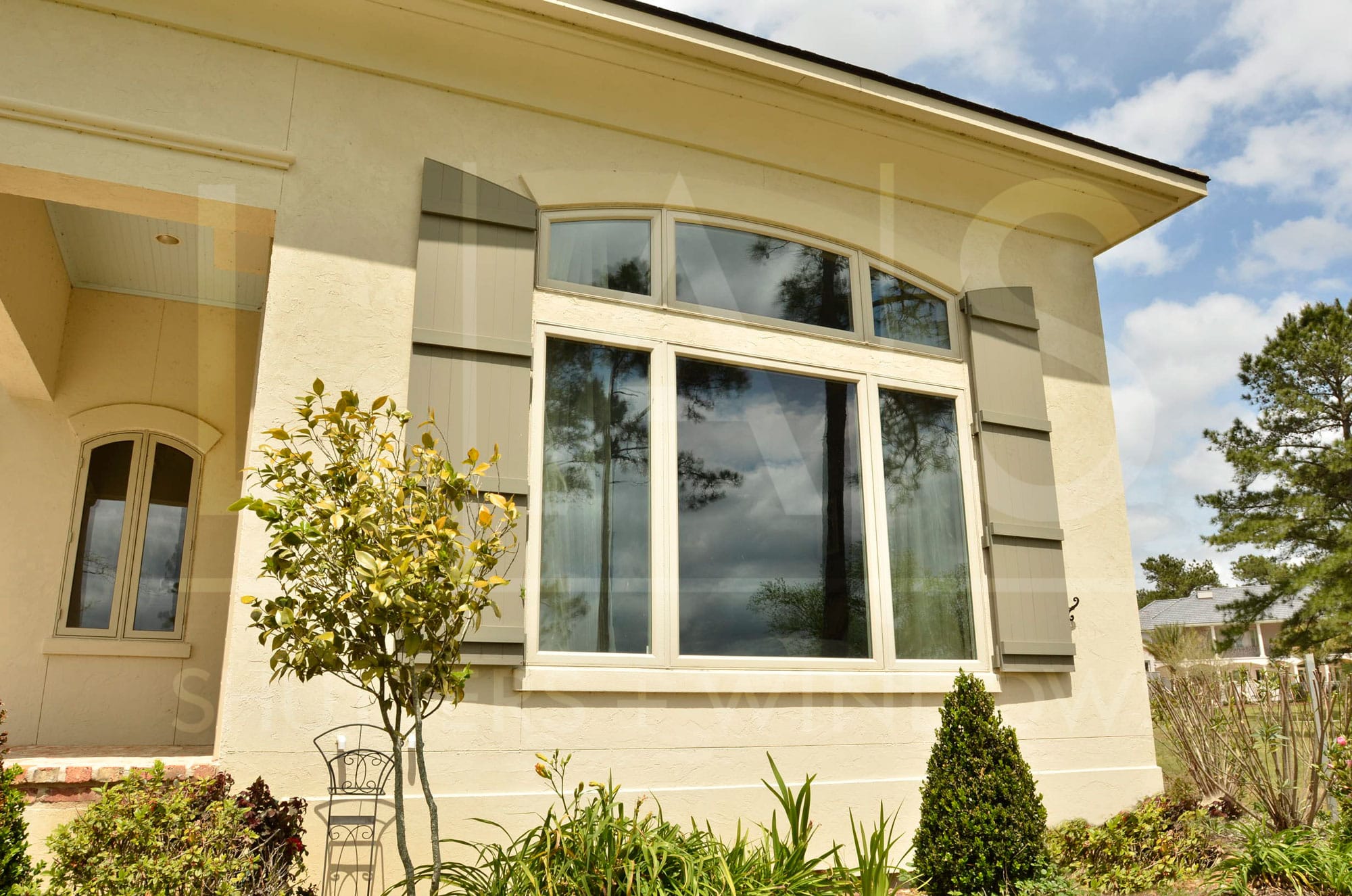 Board and Batten Shutters on Tan home